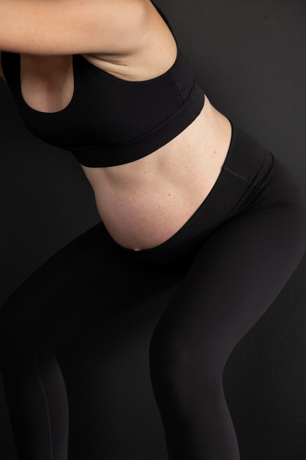 Momday pregnancy workout blog photo of pregnant woman in workout clothes doing kegels to prepare for birth